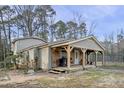 Welcoming covered front porch with wooden posts and rustic decor elements at 577 Dixon Rd # D, Willow Springs, NC 27592