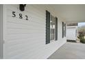 Close up of home showing siding, windows, and address numbers at 582 Ebenezer Church Rd, Coats, NC 27521