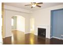 Spacious living room featuring hardwood floors, a fireplace, and an open layout at 8504 Lasilla Way, Raleigh, NC 27616