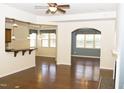 Open-concept living area with hardwood floors, a breakfast bar, and a view into the dining room at 8504 Lasilla Way, Raleigh, NC 27616