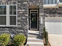 Close-up of townhome entrance with stone archway, steps, and visible house number at 8620 Secreto Dr, Raleigh, NC 27606