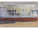 Charming front porch with white railing and brick foundation at 902 Zion Church Rd, Sanford, NC 27330