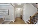 Elegant foyer featuring hardwood floors, stairway, and stylish lighting, creating a welcoming entrance at 913 Thimbleweed Way, Wake Forest, NC 27587