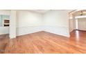 Spacious living room with hardwood floors and wainscoting at 9813 Derbton Ct, Raleigh, NC 27617