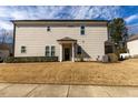 The backyard has a small porch and a yard needing some landscaping love at 100 Pinto Saddle Ct, Garner, NC 27529