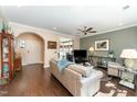 Inviting living room featuring hardwood floors, neutral walls, a ceiling fan, and comfortable seating at 1009 Restoration Dr, Durham, NC 27703