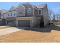 Charming two-story home with a two-car garage and inviting brick and siding exterior at 1015 Rexburg Dr, Cary, NC 27513