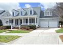 Beautiful exterior with a spacious driveway and a well-maintained front lawn leading to a welcoming entrance at 103 Glade St, Chapel Hill, NC 27516