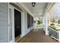 Inviting covered porch with rocking chairs, offering a relaxing outdoor space and charming curb appeal at 103 Glade St, Chapel Hill, NC 27516