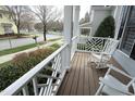 Covered porch with comfortable seating, providing an ideal spot to enjoy the neighborhood views at 103 Glade St, Chapel Hill, NC 27516