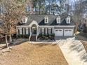 Beautiful two-story home with a two-car garage,dormer windows, and a well-maintained lawn at 104 Glenmore Rd, Cary, NC 27519