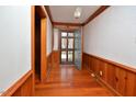 Inviting foyer with hardwood floors, wood paneling, and an open view of the front door at 104 Parker St, Oxford, NC 27565