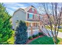 Beautiful two-story home featuring mixed siding, manicured lawn, and inviting front porch with white railings at 105 Presley Snow Ct, Holly Springs, NC 27540