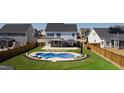 Aerial view of a backyard with a kidney-shaped pool and patio area at 1213 Valley Dale Dr, Fuquay Varina, NC 27526