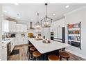 Bright and airy kitchen with a large center island, white cabinets, pendant lighting, and stainless steel appliances at 1213 Valley Dale Dr, Fuquay Varina, NC 27526