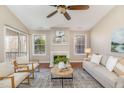 Bright living room with hardwood floors, fireplace, and large windows with access to outdoor patio at 1221 Renshaw Ct, Cary, NC 27518