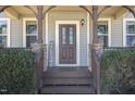 Inviting front entrance featuring a classic door, stone accents, and a welcoming porch area at 145 Carissa Dr, Smithfield, NC 27577