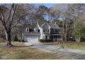 Two-story home with an attached garage, front porch, long driveway, and established landscaping at 1501 Ramson Ct, Raleigh, NC 27603