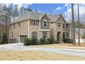 Beautiful two-story home featuring a brick and stone facade, attached garage, and manicured landscaping at 156 Stoney Creek Way, Chapel Hill, NC 27517