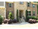 Inviting front entrance with stone steps, elegant landscaping, and a detailed front door at 156 Stoney Creek Way, Chapel Hill, NC 27517