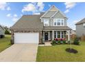 Inviting two-story home with a stone facade, covered front porch, two car garage and beautifully landscaped front yard at 190 Hickory Run Ln, Franklinton, NC 27525