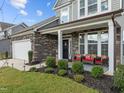 Charming front porch with stone accents and an inviting seating area at 190 Hickory Run Ln, Franklinton, NC 27525