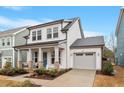 Stylish home with a front porch, attached garage, and a well-maintained lawn and landscape at 190 Retreat Dr, Fuquay Varina, NC 27526