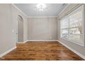 Bright living room with beautiful hardwood floors and a large window with blinds at 1938 Glenkirk Dr, Burlington, NC 27215