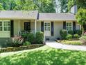 Delightful home with a cozy porch, beautiful landscaping, and classic architectural details at 2001 Manuel St, Raleigh, NC 27612