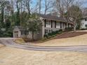 Exterior shot of a house showing the driveway leading to a garage with well-maintained landscaping at 2001 Manuel St, Raleigh, NC 27612