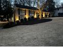Exterior of a beautiful home illuminated at dusk, showcasing its lovely landscaping and architecture at 2001 Manuel St, Raleigh, NC 27612