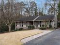 Front exterior view with mature trees and landscaping highlighting the house's curb appeal at 2001 Manuel St, Raleigh, NC 27612