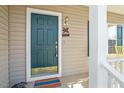 Close-up of the home's front door with a turtle 'Welcome' sign and sidelight windows at 2152 Haig Point Way, Raleigh, NC 27604