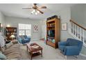 Cozy living room with a ceiling fan and plush armchairs next to the staircase at 2152 Haig Point Way, Raleigh, NC 27604