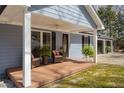 Inviting front porch with decorative plants and comfortable seating, offering a cozy entrance at 220 Choctaw Dr, Louisburg, NC 27549