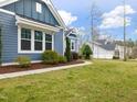 Landscaped front yard and sidewalk showcase the home's curb appeal and peaceful setting at 2253 Greenbrook Ln, Durham, NC 27705