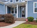 Inviting front porch with seating area and manicured landscaping at the entrance at 2253 Greenbrook Ln, Durham, NC 27705