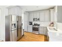 Modern kitchen featuring stainless steel appliances, white subway tile and grey cabinetry at 2431 Winburn Ave, Durham, NC 27704