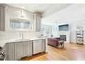 Sun-filled living room showcases a sleek fireplace and open layout to the kitchen at 2431 Winburn Ave, Durham, NC 27704