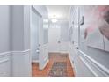 Bright hallway features hardwood floors, crisp white trim, and elegant wall decor, creating a welcoming entrance at 2451 Memory Ridge Dr, Raleigh, NC 27606