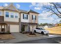 Charming townhome with stone accents and a well-maintained front yard with healthy, young tree at 3015 Cypress Lagoon Ct, Durham, NC 27703