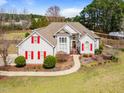 Charming two-story home with red shutters, manicured lawn and mature trees at 3112 Gold Dust Ln, Willow Springs, NC 27592