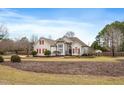 Traditional two-story home with a landscaped yard, red shutters, and mature trees at 3112 Gold Dust Ln, Willow Springs, NC 27592