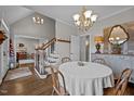 Traditional dining room showcasing hardwood floors, chandelier, and staircase visible in the background at 3116 Kensington Pl, Burlington, NC 27215