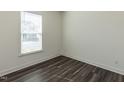 Cozy bedroom featuring new hardwood floors, a window, and crisp white walls at 3354 Brunot St, New Hill, NC 27562