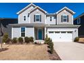 Charming two-story home with a blue front door and well manicured landscaping at 3354 Brunot St, New Hill, NC 27562