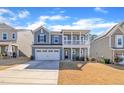 Two-story home with welcoming curb appeal, modern design, and a manicured lawn at 3381 Lovage Drive Dr, Apex, NC 27502
