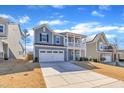 Attractive two-story home with a front-facing garage and quaint second story porch at 3381 Lovage Drive Dr, Apex, NC 27502