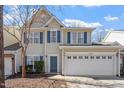 Attractive home boasts a spacious two-car garage and complementary blue shutters at 3439 Archdale Dr, Raleigh, NC 27614