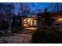 Charming home featuring stone walkway, wooden steps, and a beautifully illuminated entryway at 3604 Pasture Rd, Hillsborough, NC 27278
